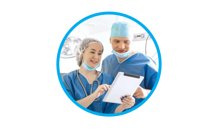 An image of a man and a woman wearing scrubs while interacting with a tablet.