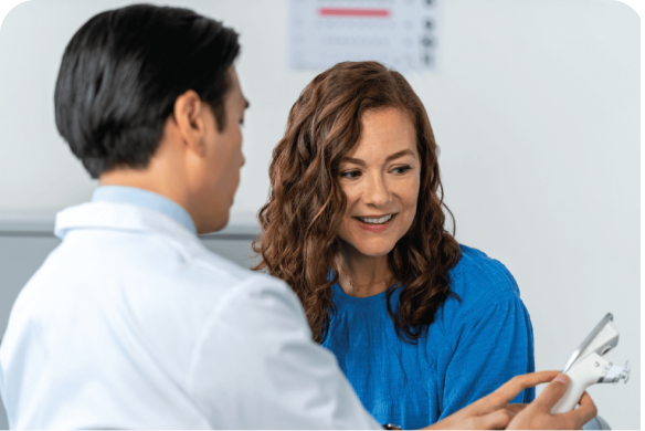 Eye doctor talking to patient about exam results