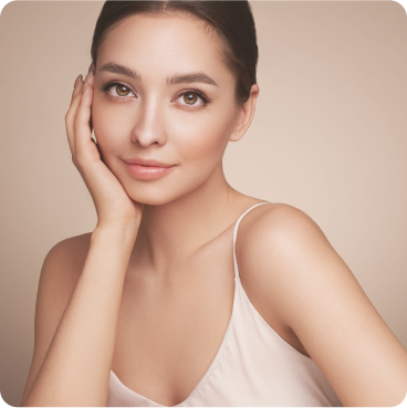 A woman smiling with a warm glow wearing color contacts.