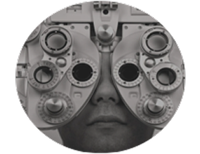 Close-up of a person's face during an eye examination, in muted grey tones