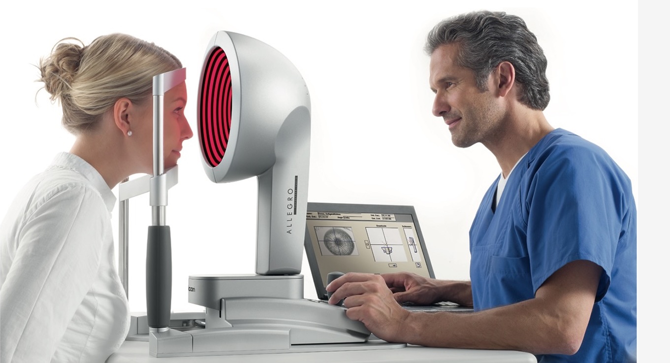 Optometrist examining a patient's eye during an eye test