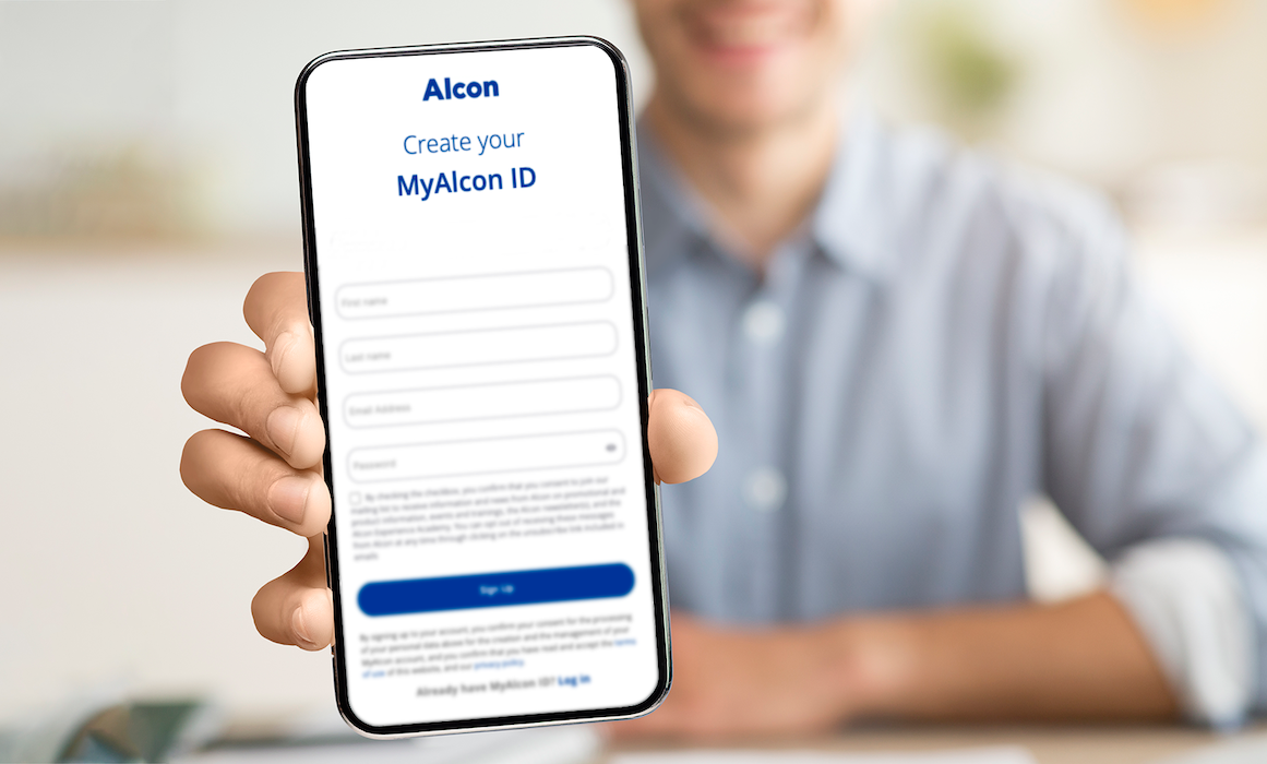 A person in a light blue shirt holds a smartphone displaying the MyAlcon ID registration page. The screen shows form fields for creating an account, with a "Sign Up" button at the bottom.