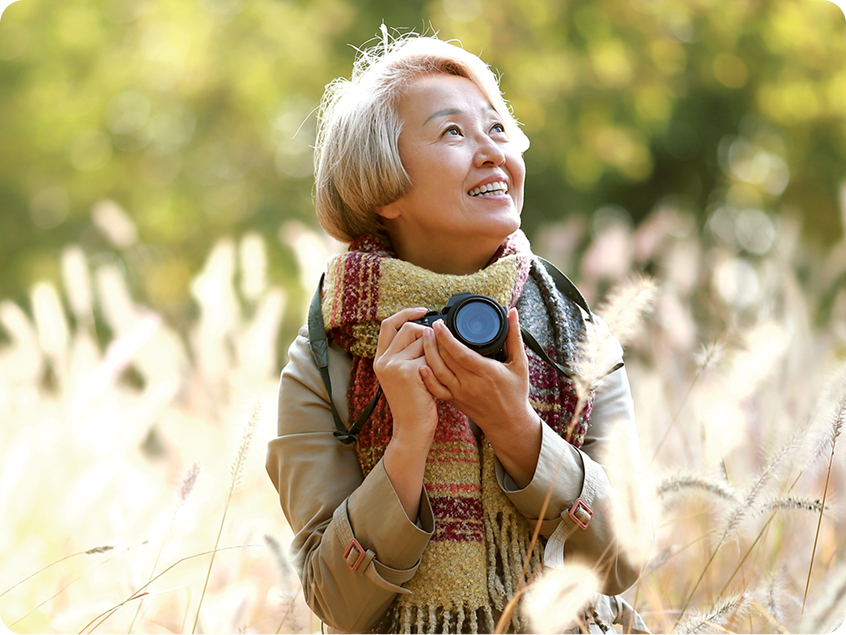 smiling woman with a camera