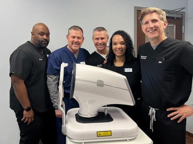 Group of smiling people at alcon product