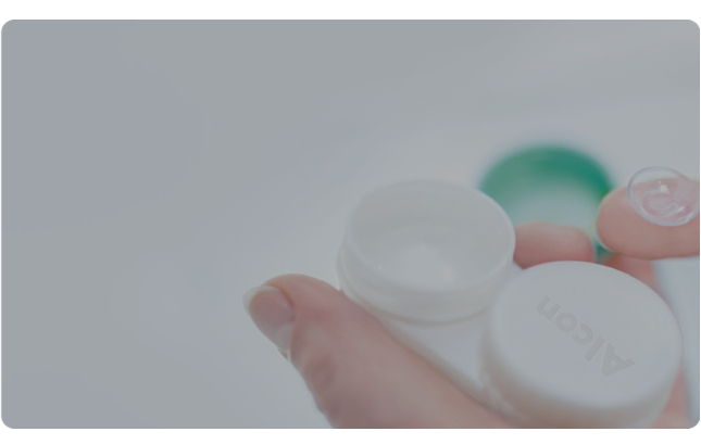 Image of lens on finger and packaging for contact lenses