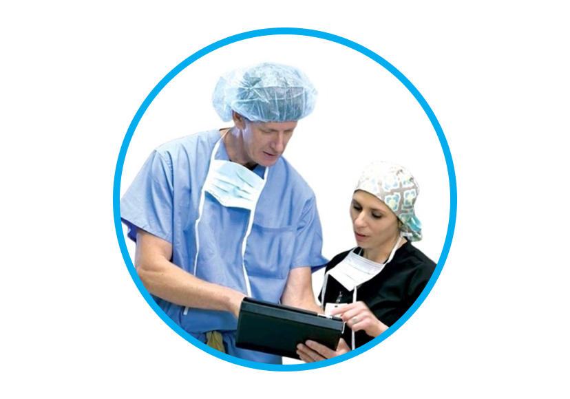 An image of a man and a woman wearing scrubs while interacting with a tablet.