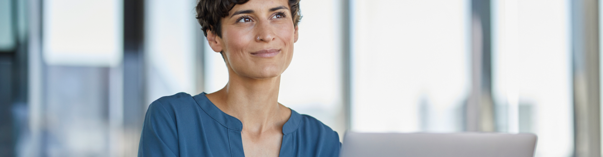 Smiling woman with a laptop in the office