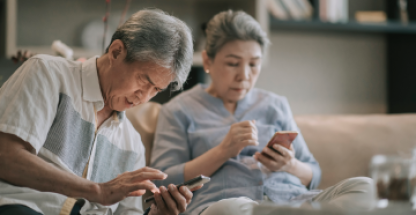 Elderly couple looking for information on their phone