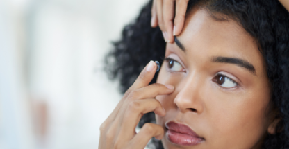Woman applying a contact lens