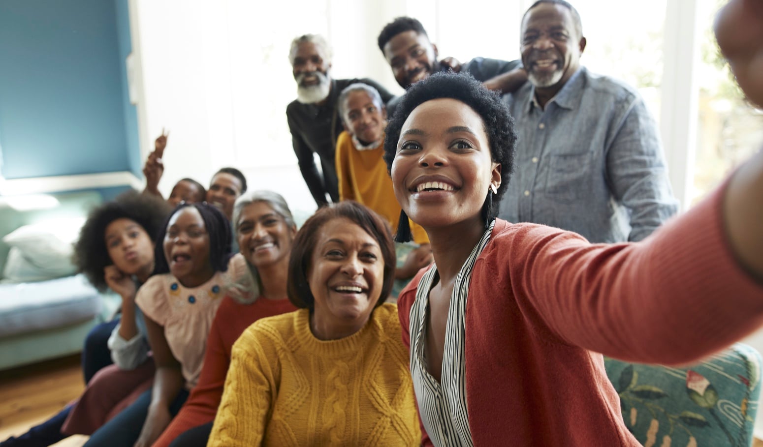 Group of people smiling and taking a selfie photo