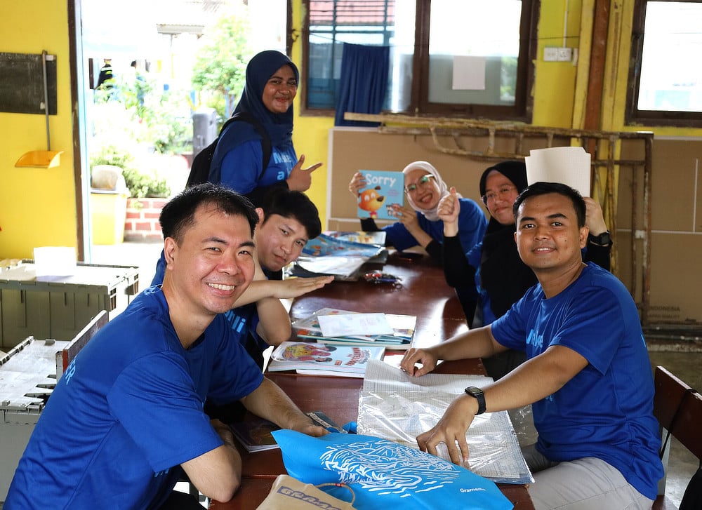 Alcon employees at a table with children's books