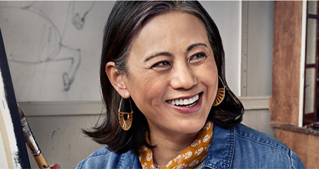 Mature woman artist dressed creatively and smiling