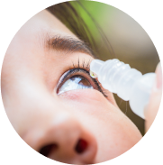 Closeup applying dry eye drops in eye