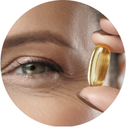 Closeup of eye and woman holding eye vitamin