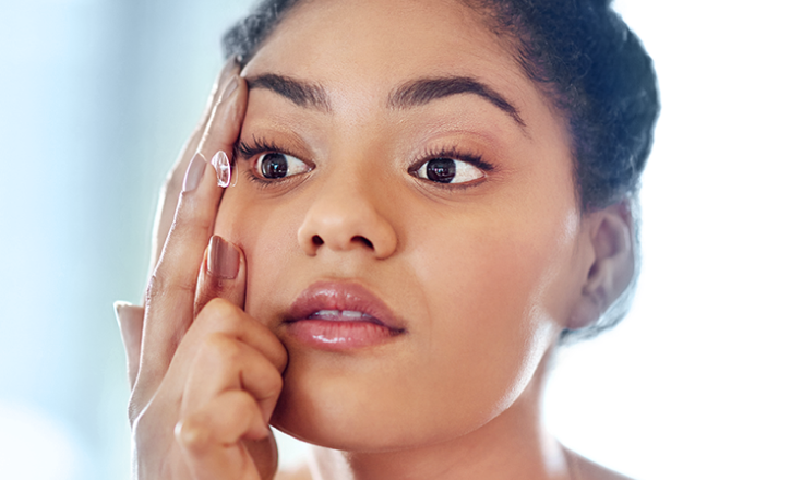 Woman applying a contact lens